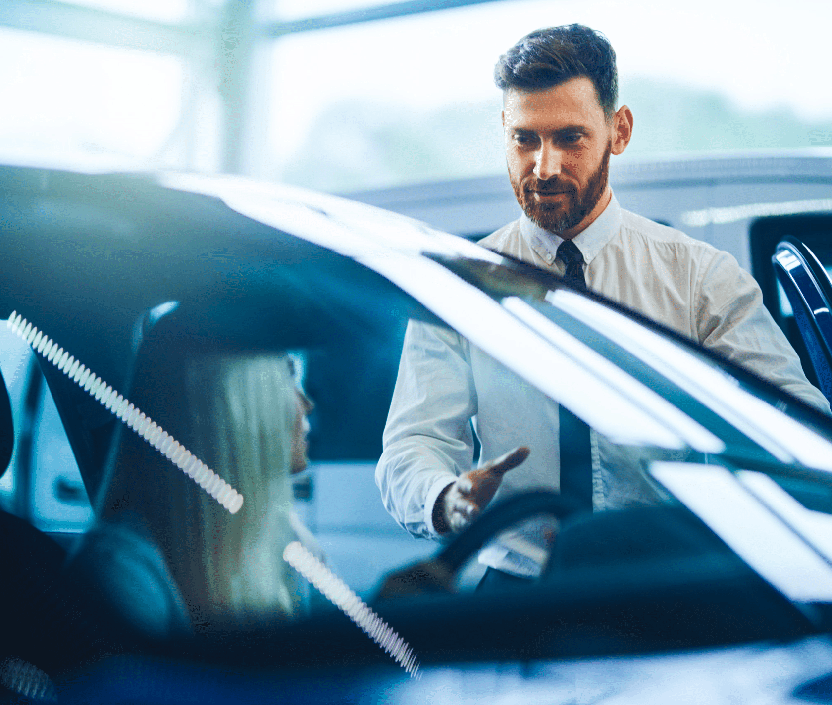 An automotive employee is talking to a customer