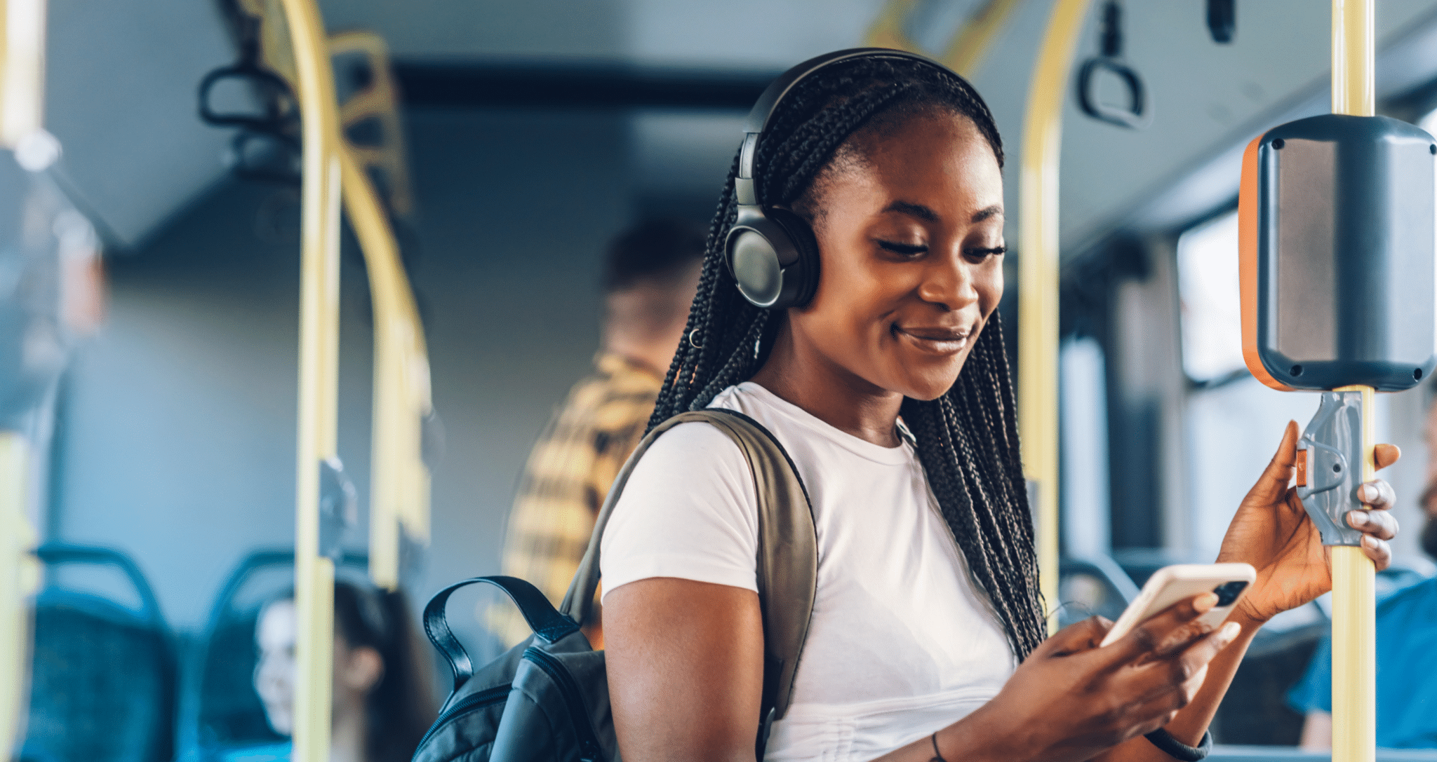 woman looking at phone on the bus